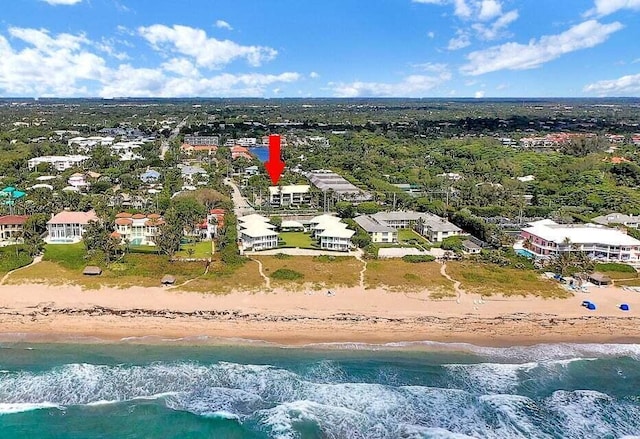 bird's eye view featuring a water view and a beach view