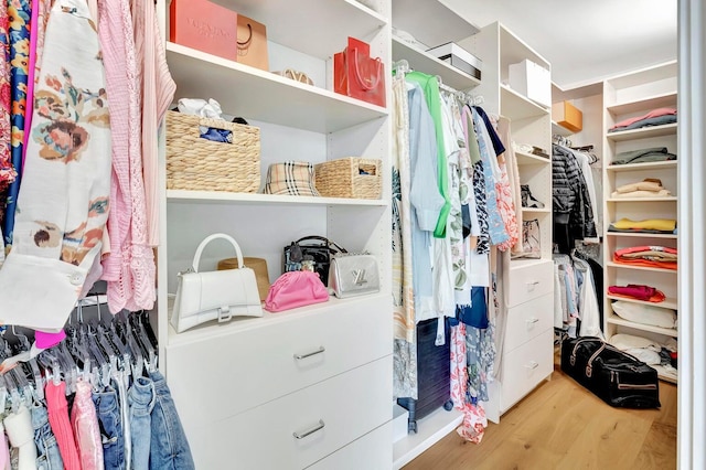 spacious closet featuring light hardwood / wood-style floors