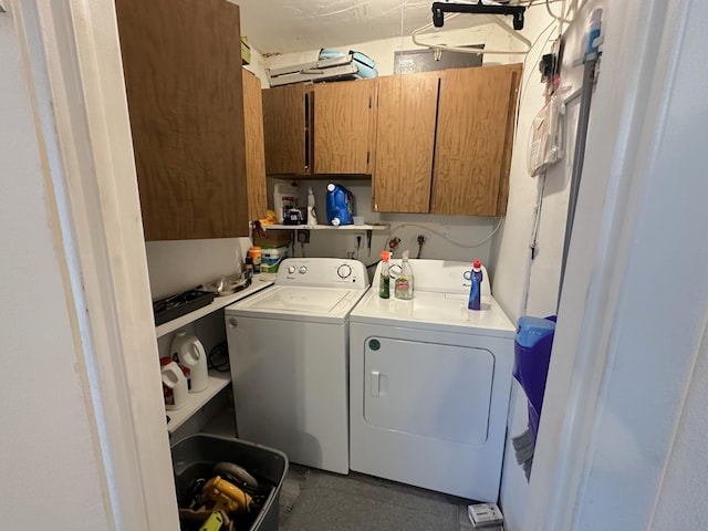 laundry room with cabinets and washing machine and clothes dryer