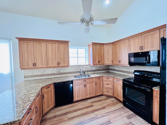 unfurnished room with high vaulted ceiling, a skylight, and light wood-type flooring