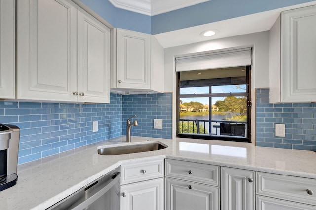 kitchen featuring decorative backsplash, sink, and white cabinets