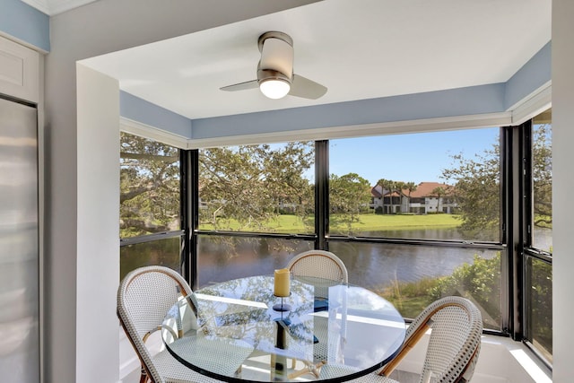 sunroom / solarium featuring ceiling fan, a water view, and a healthy amount of sunlight