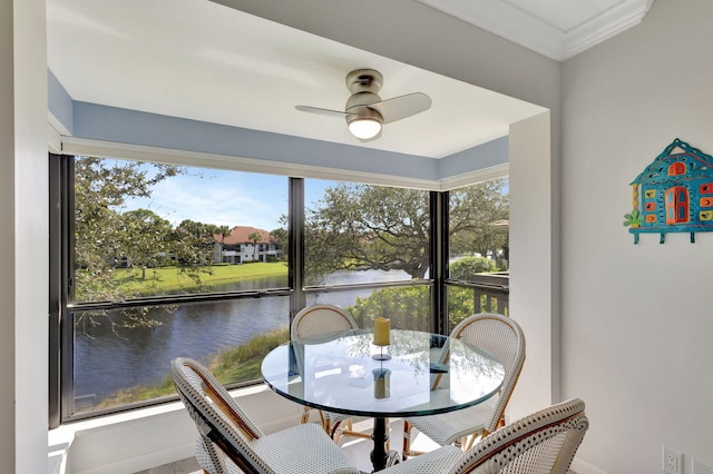 dining space featuring a water view, plenty of natural light, and ceiling fan