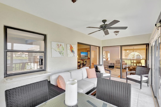 living room featuring ceiling fan and light tile patterned floors