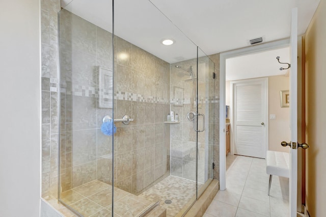 bathroom with tile patterned floors and an enclosed shower