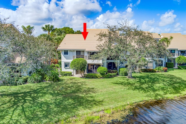 exterior space with a water view and a front yard