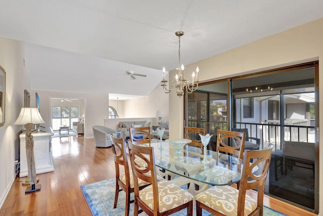 dining area featuring ceiling fan with notable chandelier and light hardwood / wood-style flooring