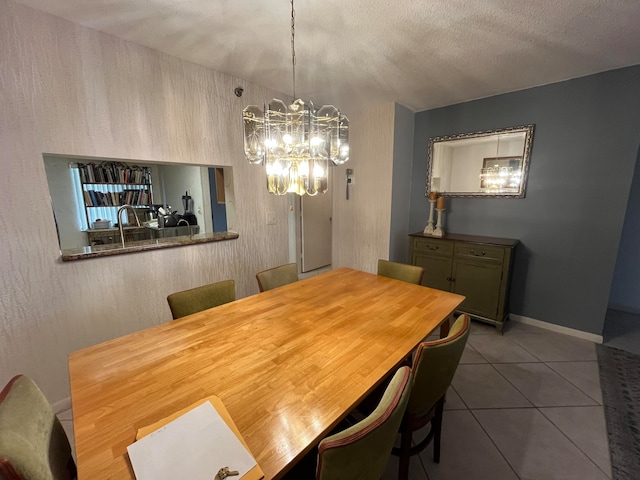 dining room featuring tile patterned flooring, a textured ceiling, and an inviting chandelier