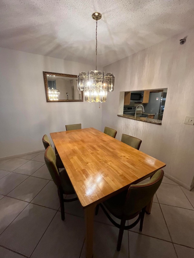 tiled dining room featuring a textured ceiling