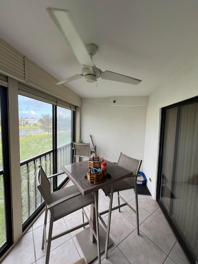 sunroom featuring ceiling fan