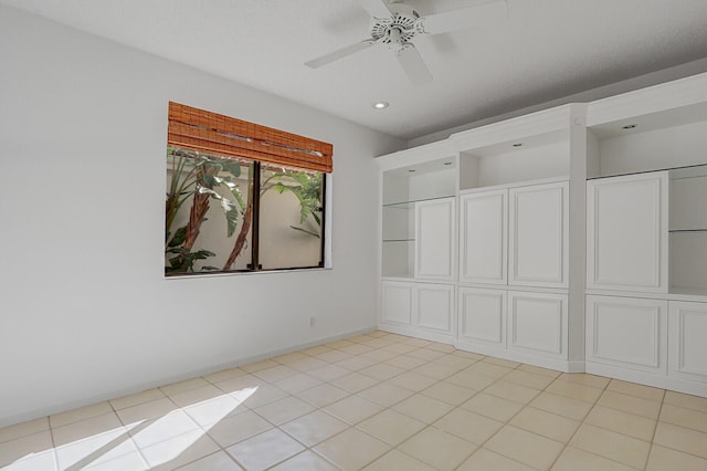 unfurnished room featuring ceiling fan and light tile patterned floors