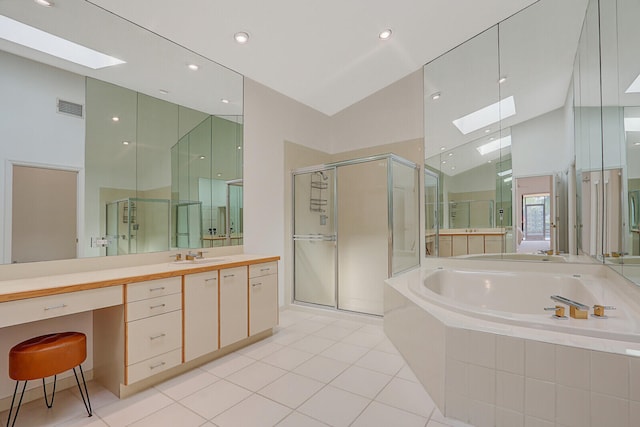 bathroom with vanity, vaulted ceiling with skylight, tile patterned floors, and shower with separate bathtub