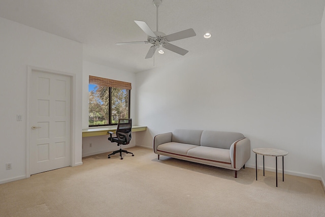 home office with ceiling fan and light carpet