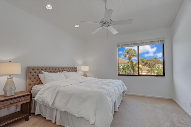 bedroom with light carpet and ceiling fan