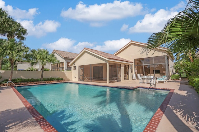 view of pool featuring a patio and a sunroom