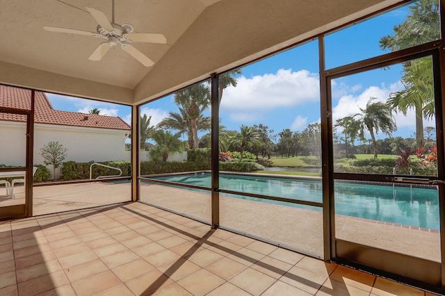 unfurnished sunroom with a wealth of natural light, ceiling fan, and vaulted ceiling