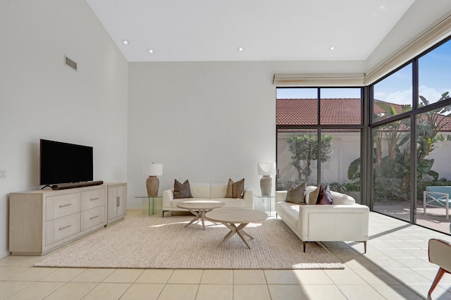 unfurnished living room featuring a wealth of natural light, high vaulted ceiling, and light tile patterned flooring