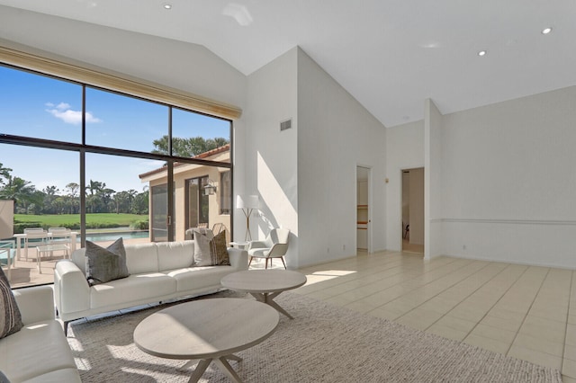 tiled living room featuring high vaulted ceiling and plenty of natural light