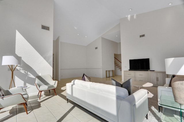 tiled living room featuring high vaulted ceiling