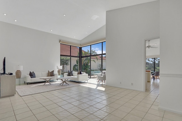 tiled living room with high vaulted ceiling and ceiling fan