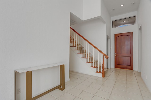 tiled entrance foyer with a high ceiling