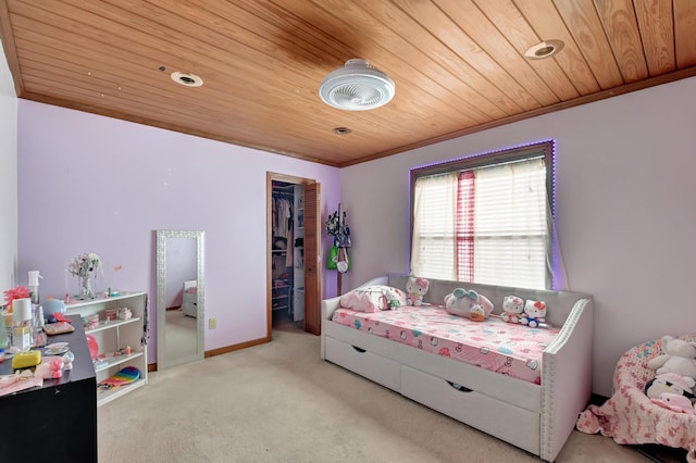 bedroom with a spacious closet, wooden ceiling, and light carpet