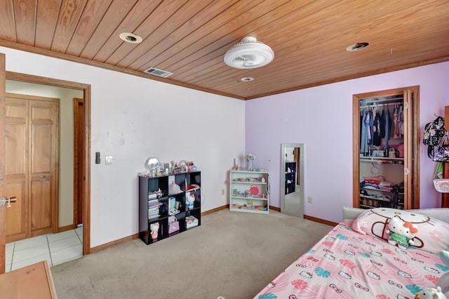 bedroom with wooden ceiling, light carpet, and a closet