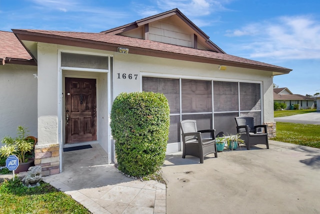 doorway to property featuring a patio area