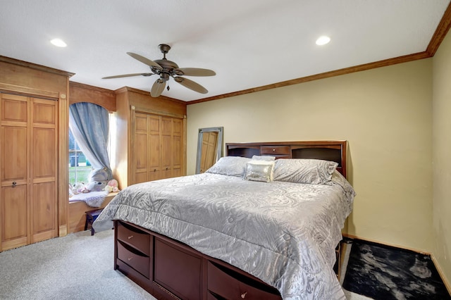 bedroom featuring ceiling fan, light colored carpet, and crown molding