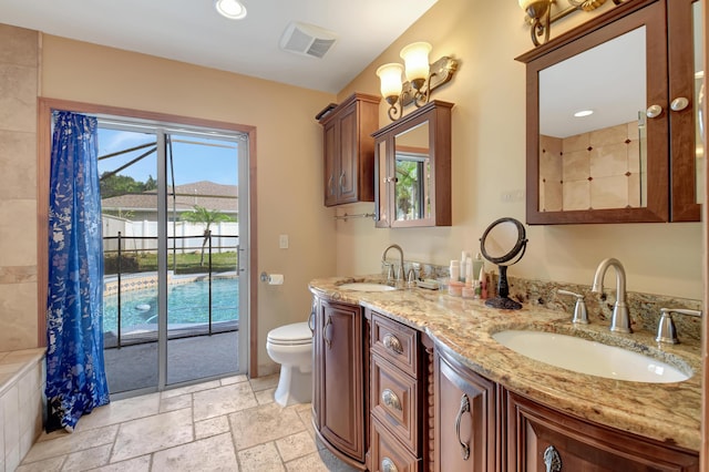 bathroom featuring a shower with curtain, vanity, and toilet