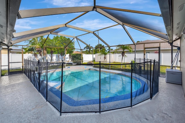 view of swimming pool with a patio area and a lanai