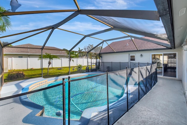 view of swimming pool with glass enclosure