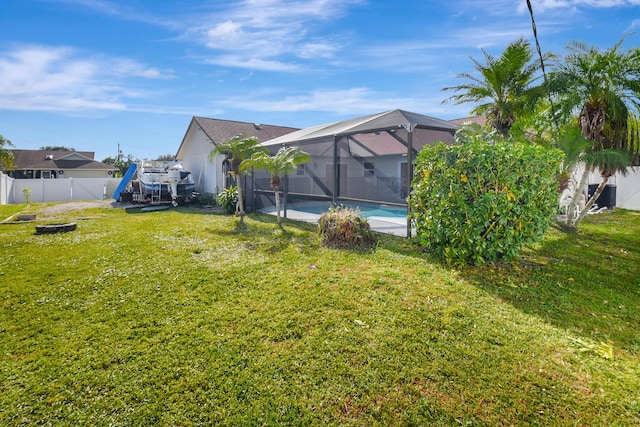 view of yard featuring a fenced in pool and a lanai