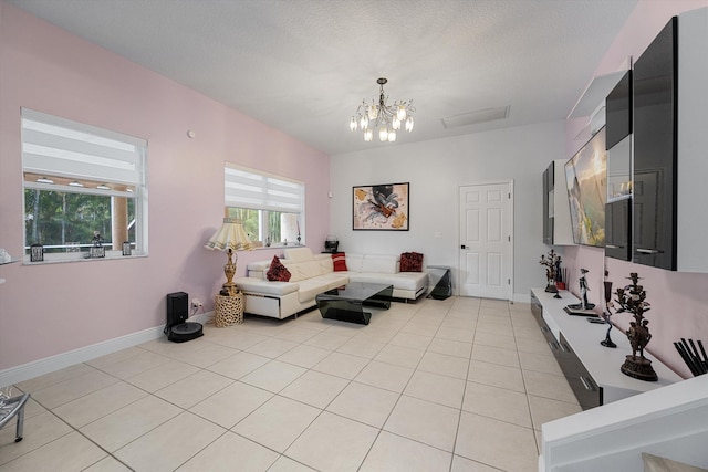 tiled living room featuring a notable chandelier and a textured ceiling