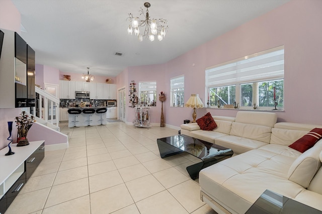 living room featuring an inviting chandelier and light tile patterned floors