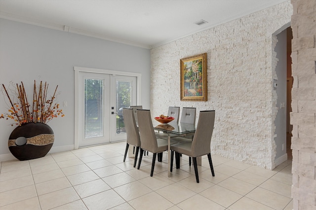 tiled dining space with french doors and ornamental molding