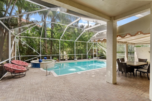 view of pool featuring an in ground hot tub, a lanai, and a patio area