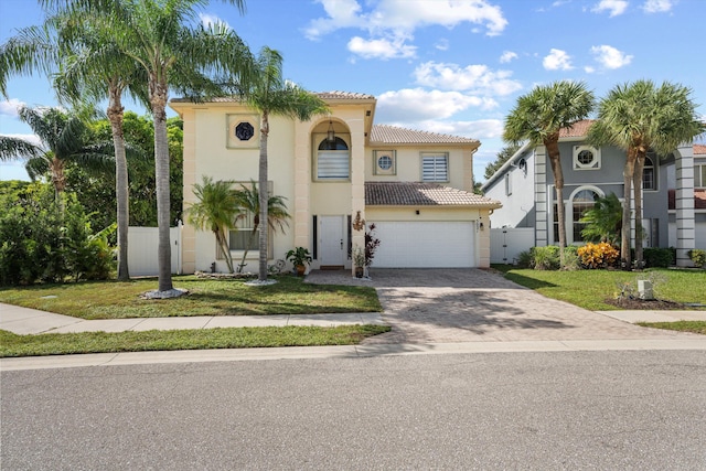 mediterranean / spanish home with a garage and a front yard