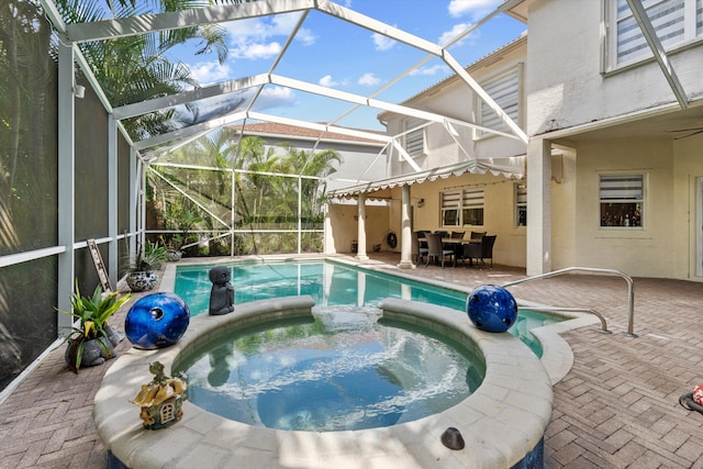 view of swimming pool with an in ground hot tub, a lanai, and a patio area