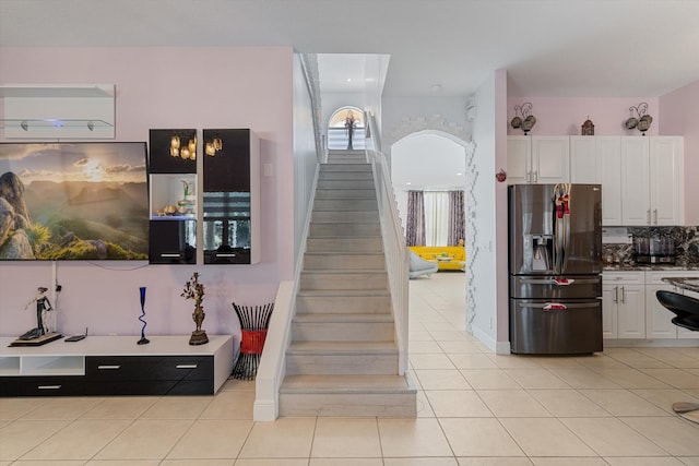 stairway featuring tile patterned flooring