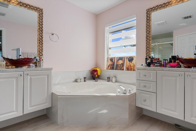 bathroom featuring vanity, hardwood / wood-style floors, and independent shower and bath