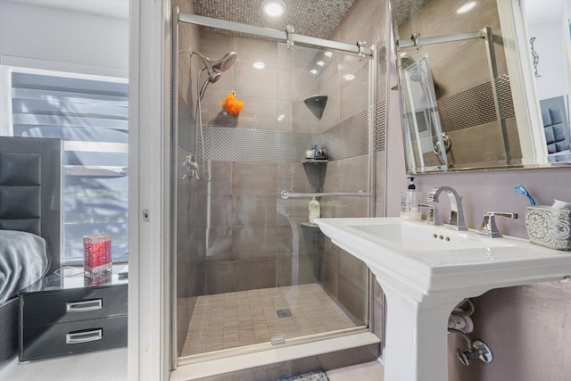 bathroom featuring a shower with shower door