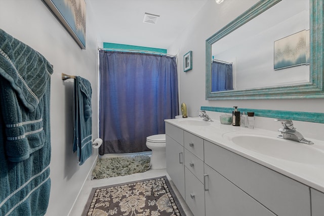 bathroom featuring vanity, tile patterned flooring, curtained shower, and toilet