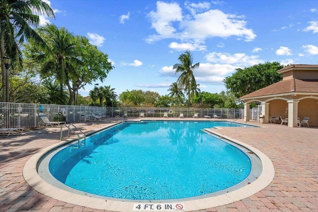 view of swimming pool featuring a patio area