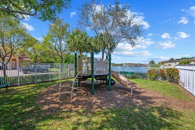 view of play area featuring a lawn and a water view