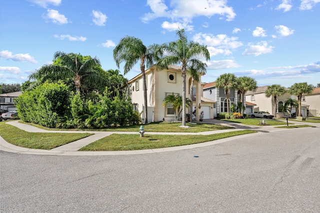 view of front of property with a garage and a front lawn