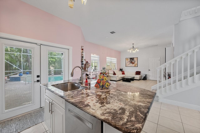 kitchen featuring a wealth of natural light, white cabinetry, dishwasher, sink, and a center island with sink