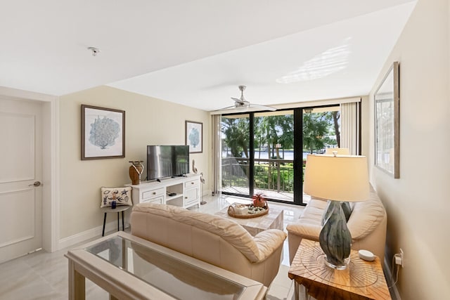 living room with expansive windows and ceiling fan