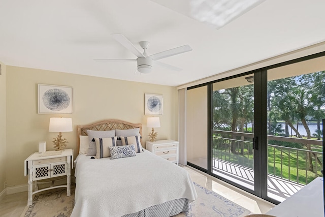 bedroom with access to outside, a wall of windows, and ceiling fan