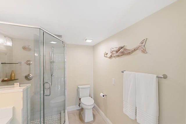 bathroom featuring toilet and a shower with shower door